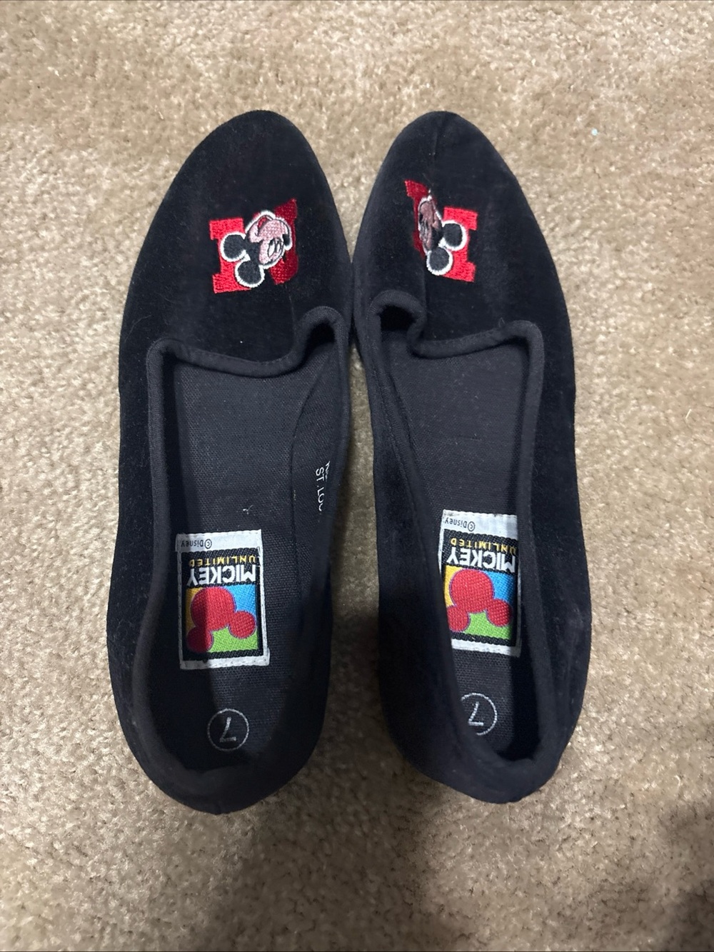 Mickey Unlimited black velvet slip-on flats featuring an embroidered Mickey Mous